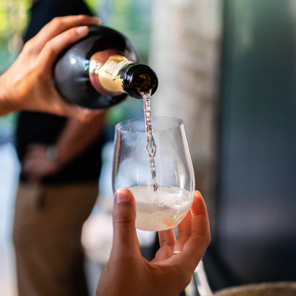 Wine pouring into a glass of wine