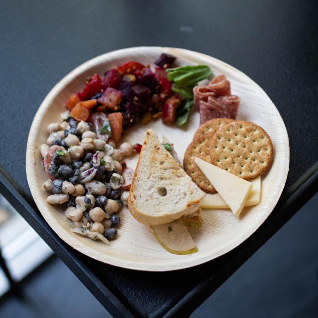 A plate of bread, crackers, beans, and beets from Frascati Market