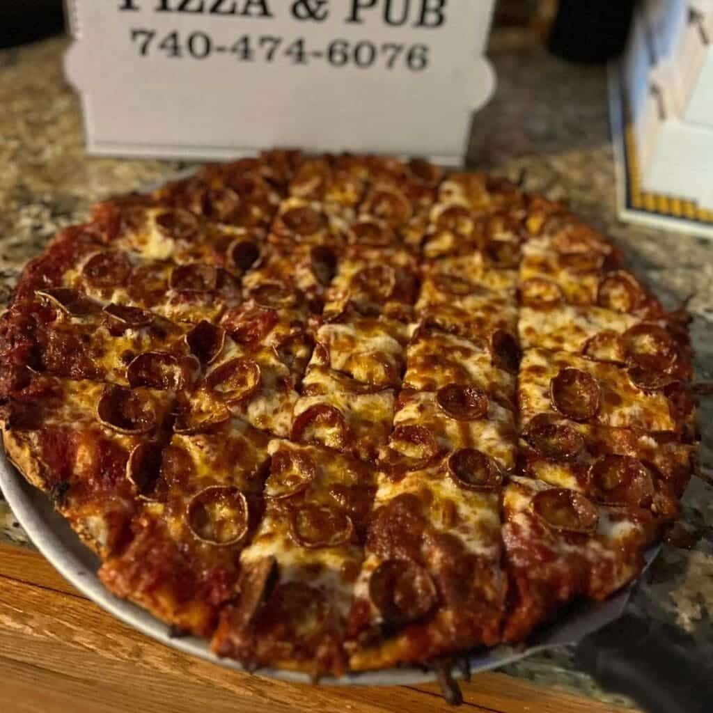 A pepperoni pizza on a peel from Gant's Pizza