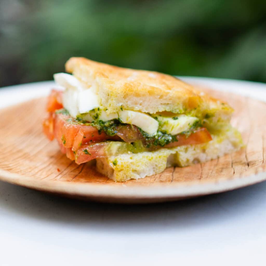 A Frascati Bruschetta sandwich on a wooden plate