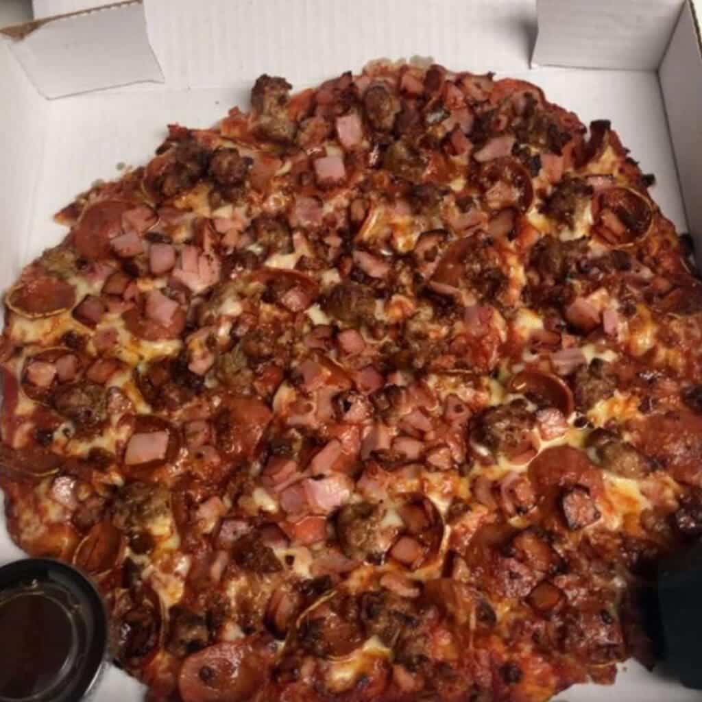 A meat lovers pizza in a delivery box from Gant's Pizza