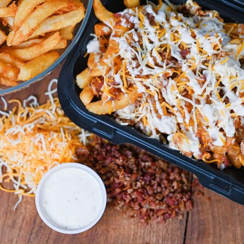 A to go box with loaded fries from Taesty's