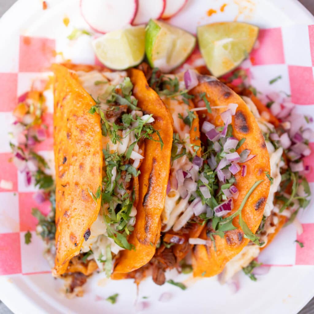 A closeup of three tacos from Los Agavez