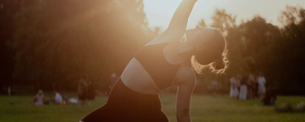 a woman doing yoga outdoors